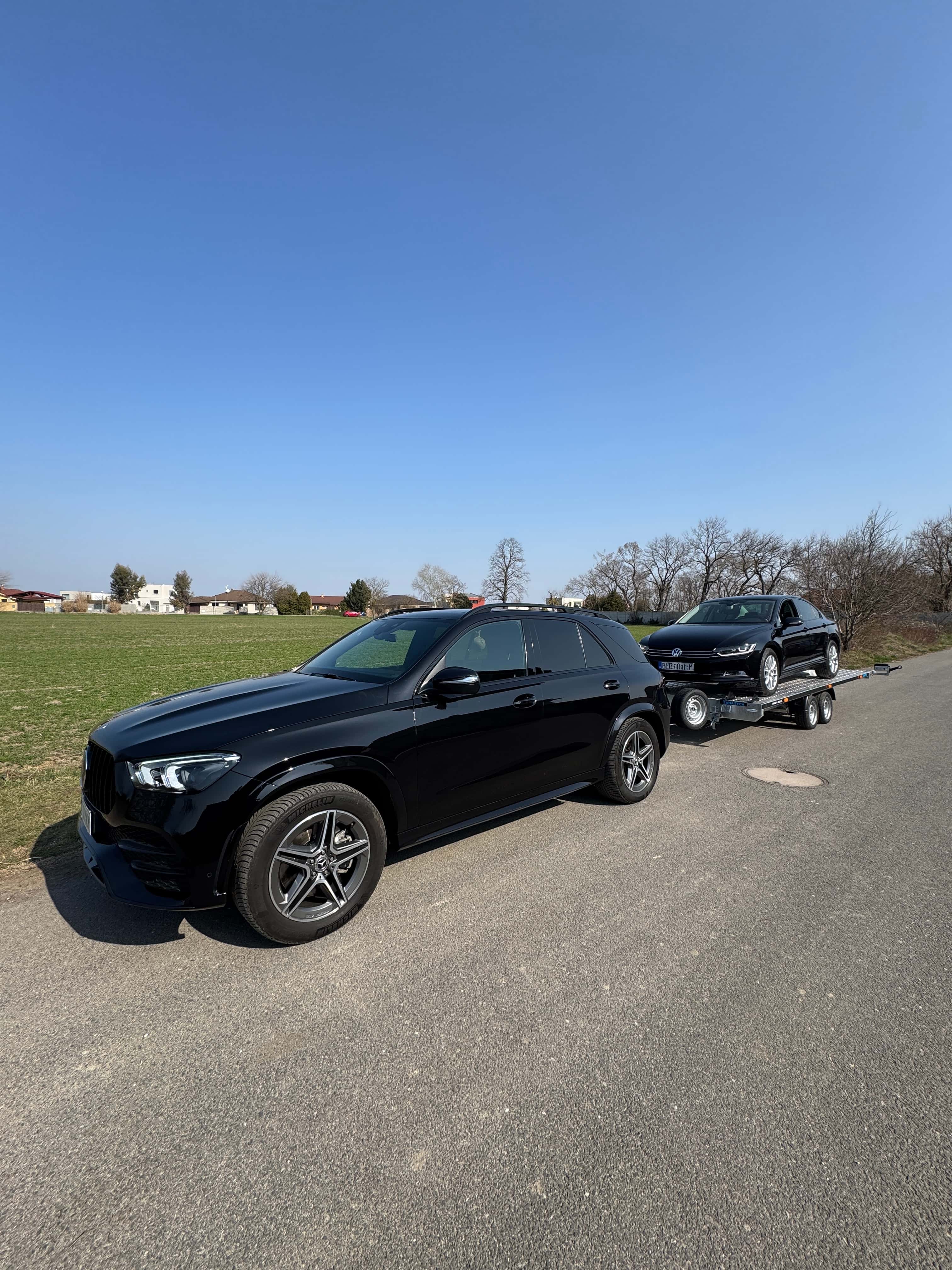 Car with trailer in the field